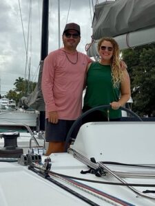 the burkes at the helm of their 2018 lagoon 450f they bought with yacht broker cynthia wummer's help